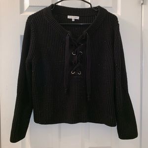 Black knit sweater with criss cross ties